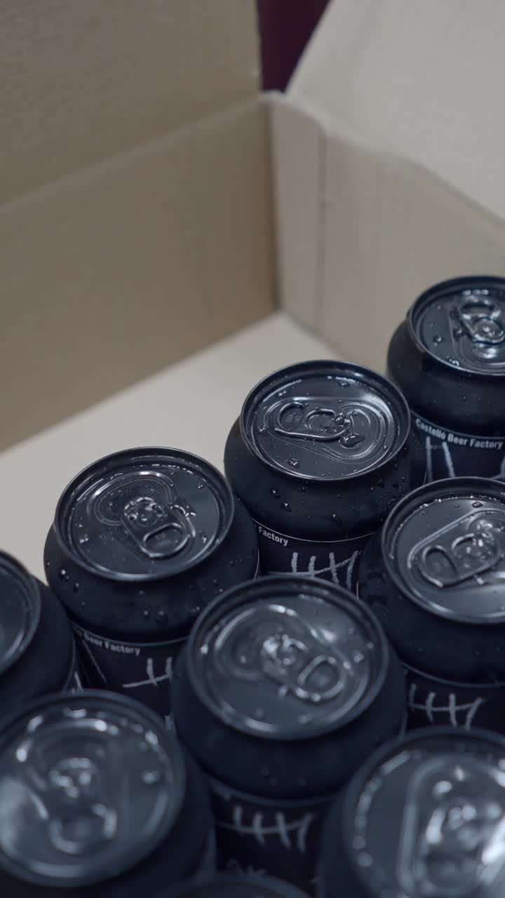 Black Beverage Cans with Condensation in a Cardboard Box