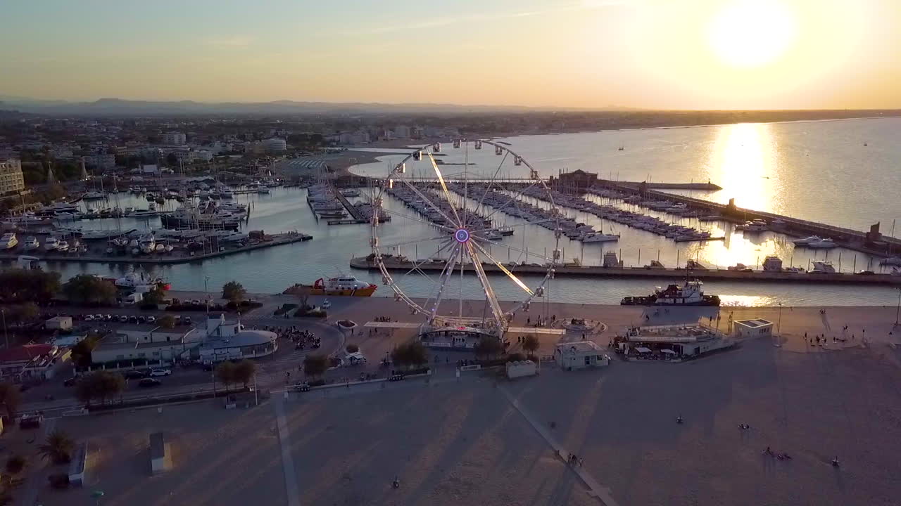 Scenic View Of Ferris Wheel Near Shoreline Beach Of Rimini, Italy At Sunset. - Aerial Shot