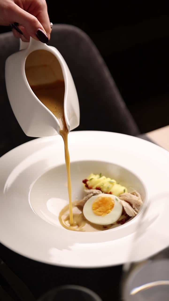 Pouring Sauce Over an Egg Dish