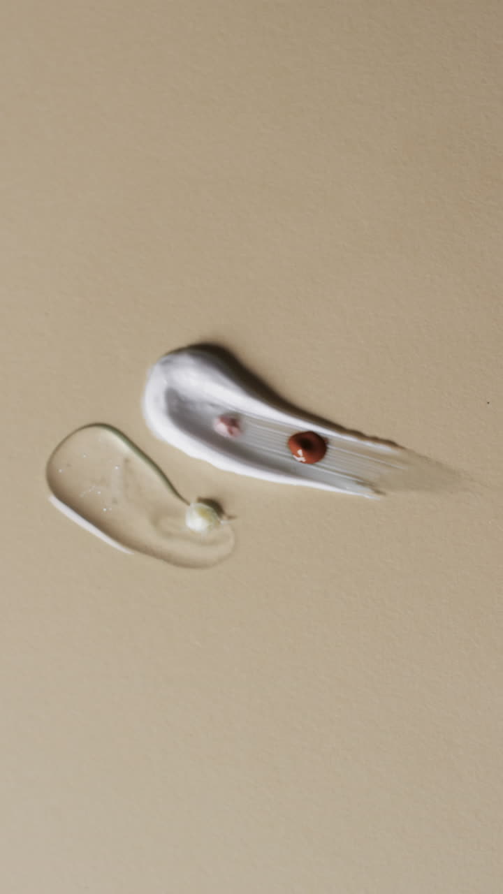 Vertical video of cream smudges with copy space on brown background