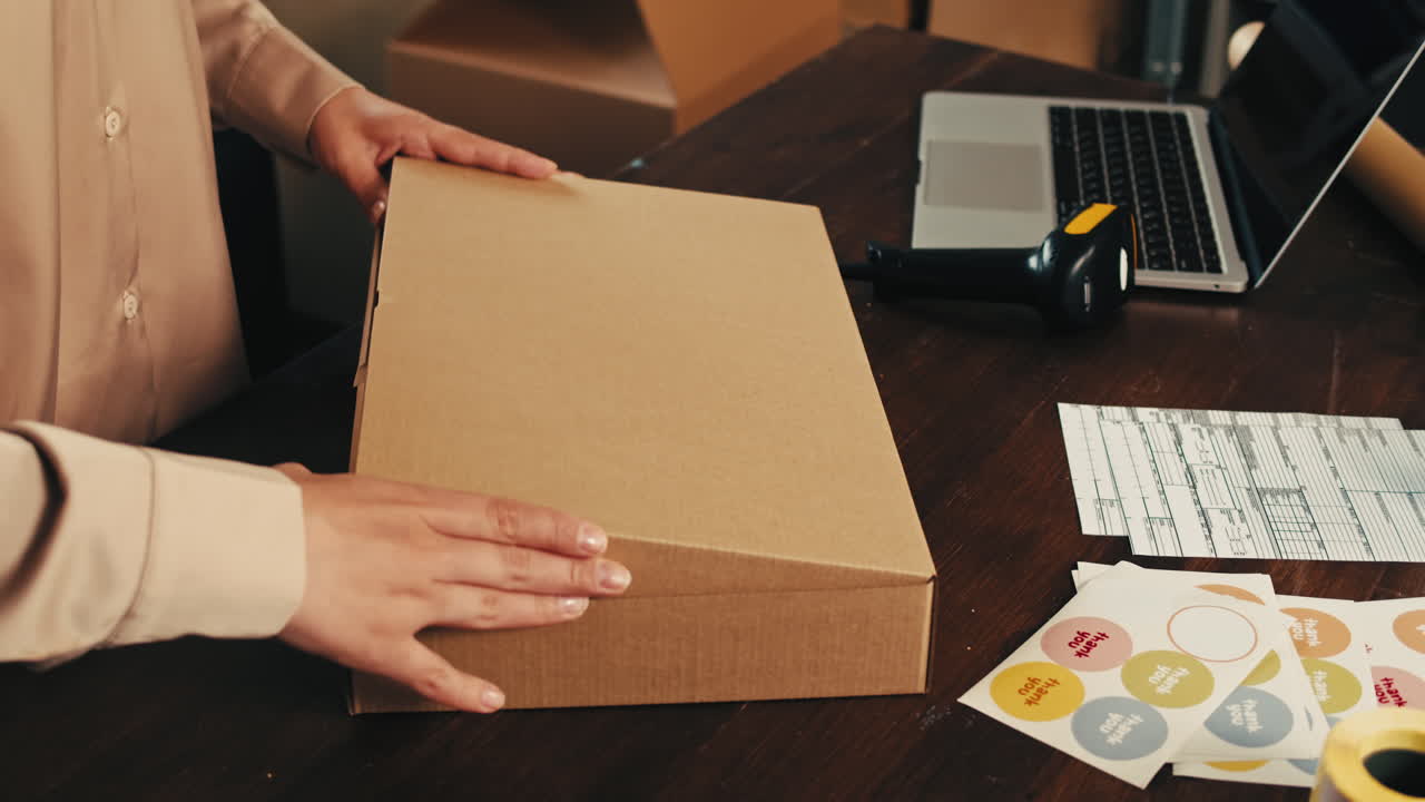 E-commerce storage shop, woman packing goods and clothes for second hand delivery market, dedicated Packaging and Shipping Workspace with Supplies and Technology for efficiency, online sales.