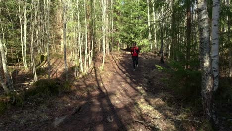 female trailrunner running down a forest trail