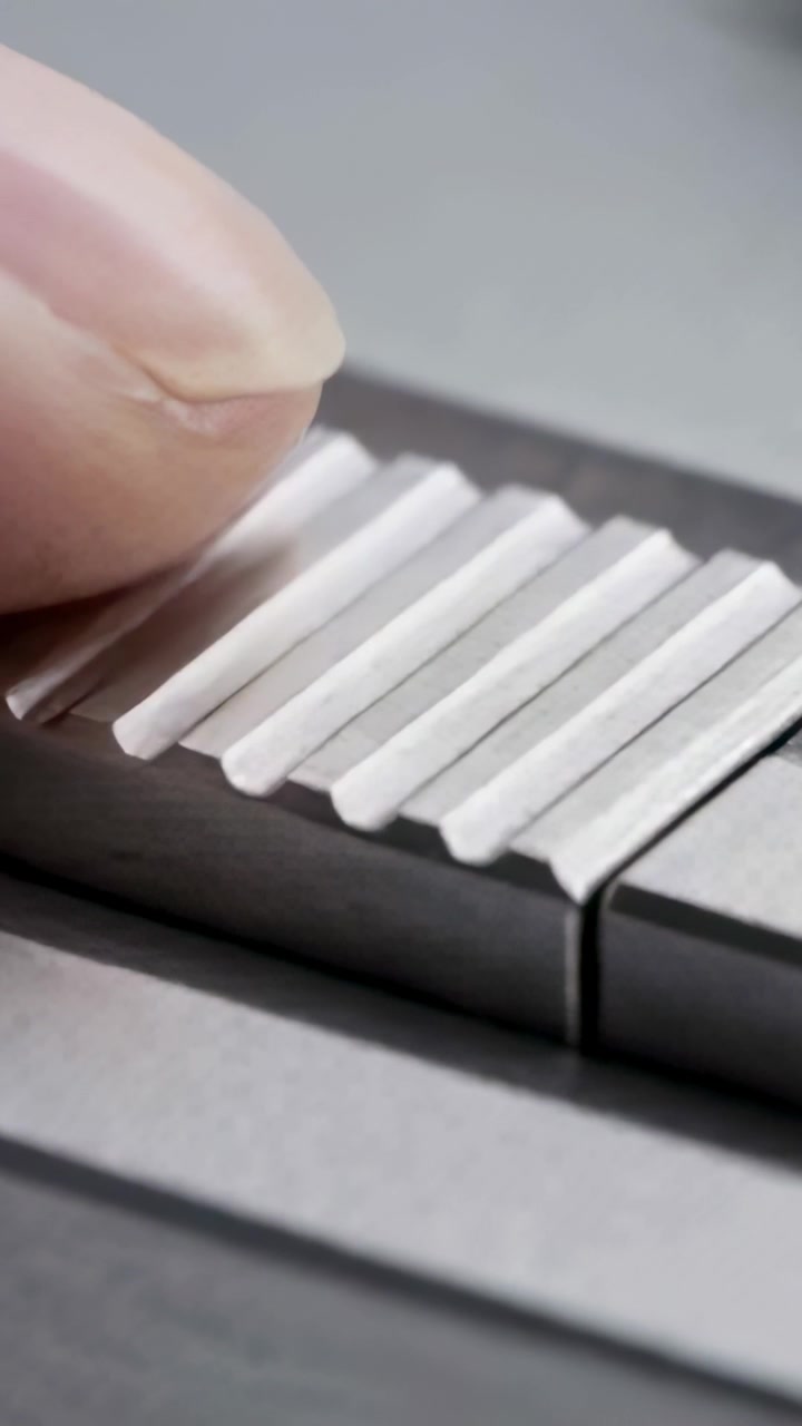 Vertical video: Fingertip entering from left, testing grooved bar by sliding right, leaving smudge