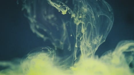 Green-ink-lingering-in-water-in-slow-motion