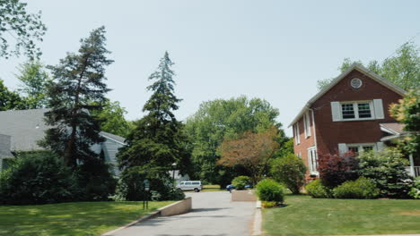 view from a car window to a typical american street houses and well-groomed territory