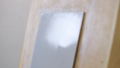 painting a surface with a paint roller