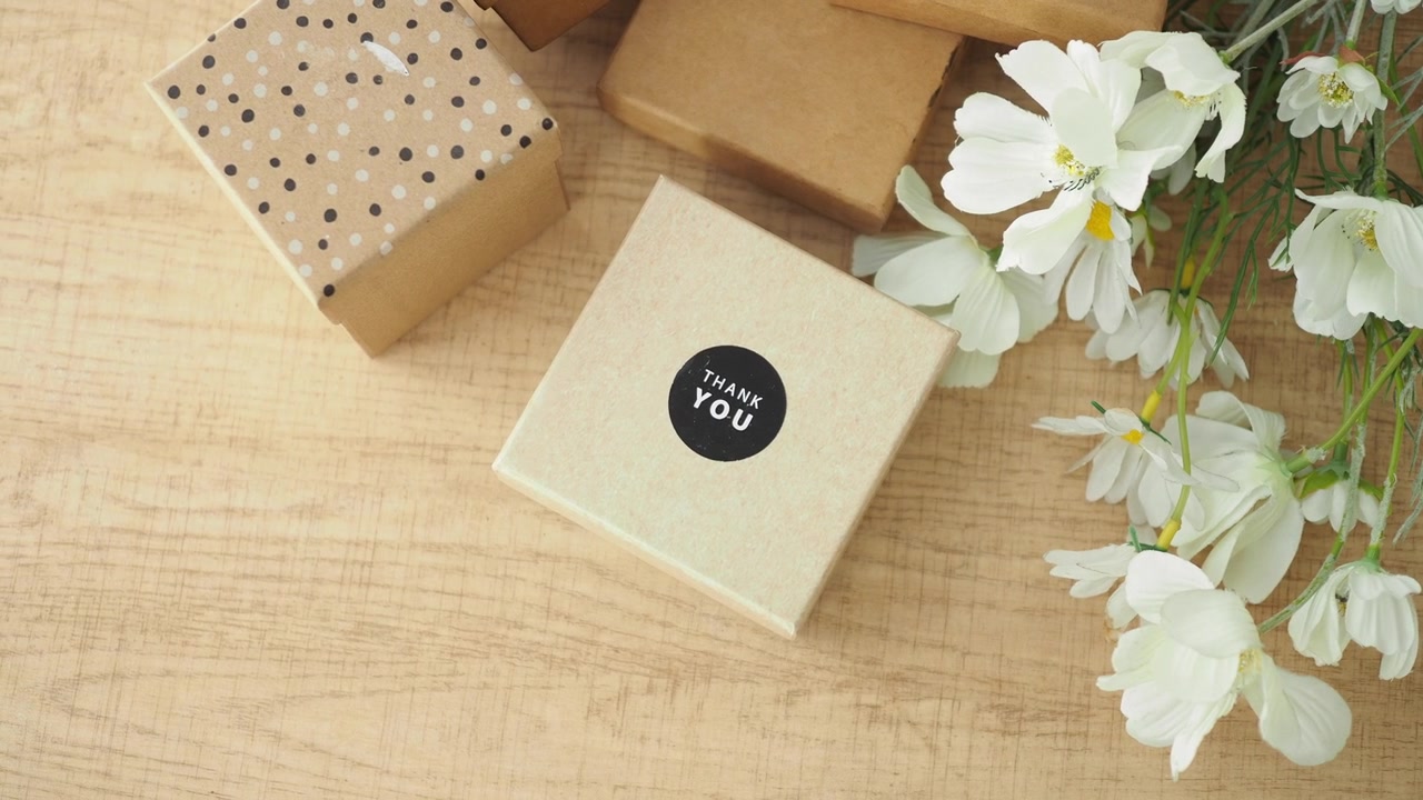 Gift Boxes with Thank You Sticker and White Flowers