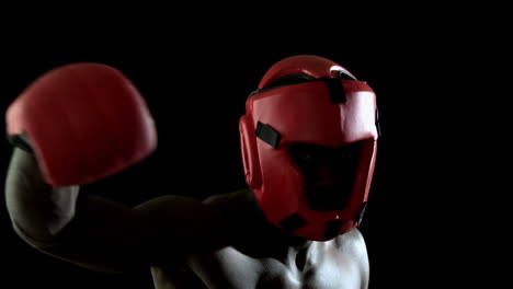 tough boxer punching with red gloves