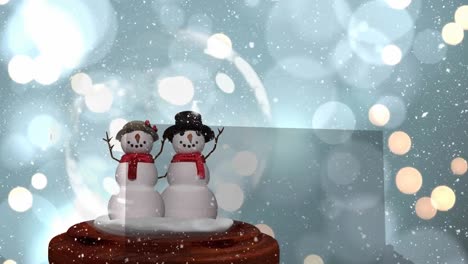 Animation-of-snow-falling-over-snow-globe-with-snowmen-and-light-spots-on-blue-background