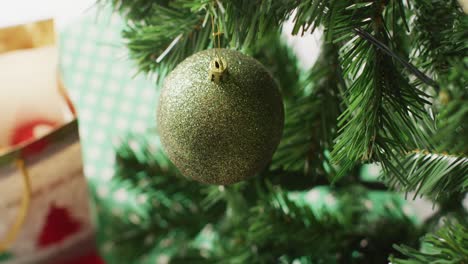 closeup of christmas balls and decorations on the green christmas tree