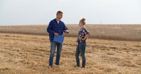 young farmers discussing at wheat field 30