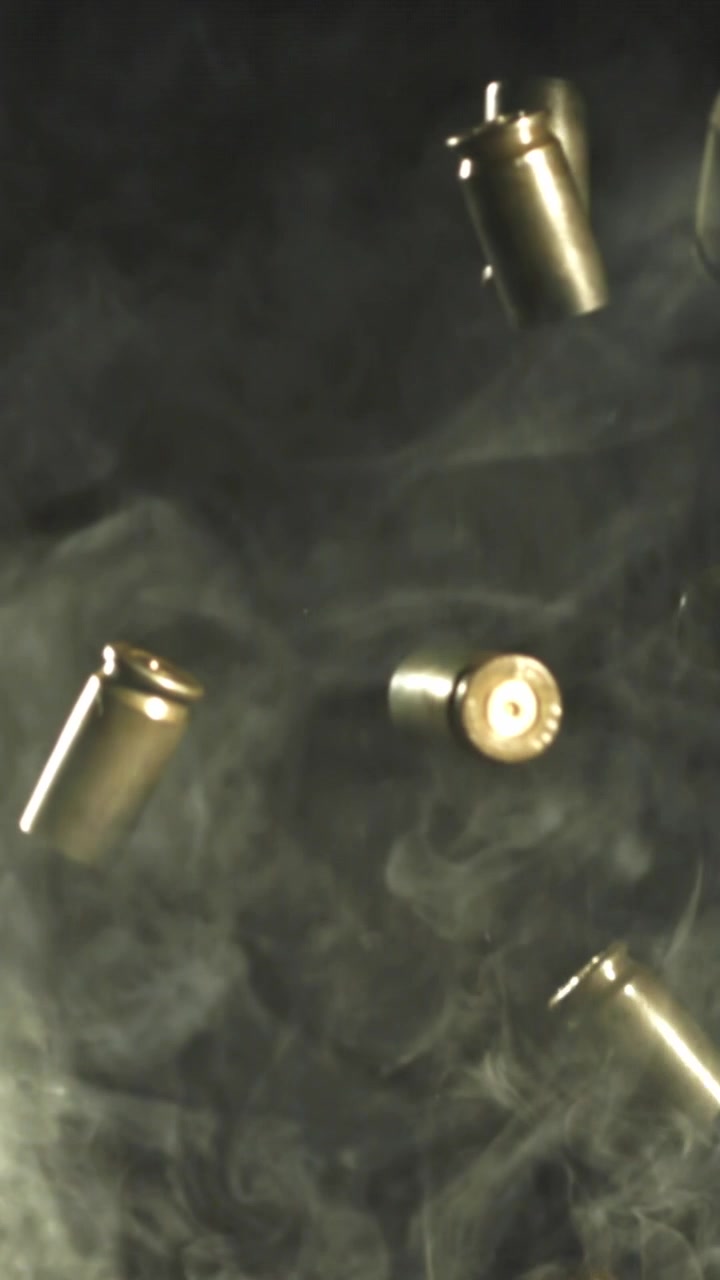 Bullet Casings Falling in Slow Motion Through Smoke