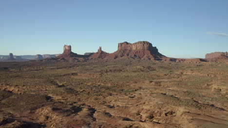 a rising drone aerial shot of monument valley in the distance, utah, arizonia