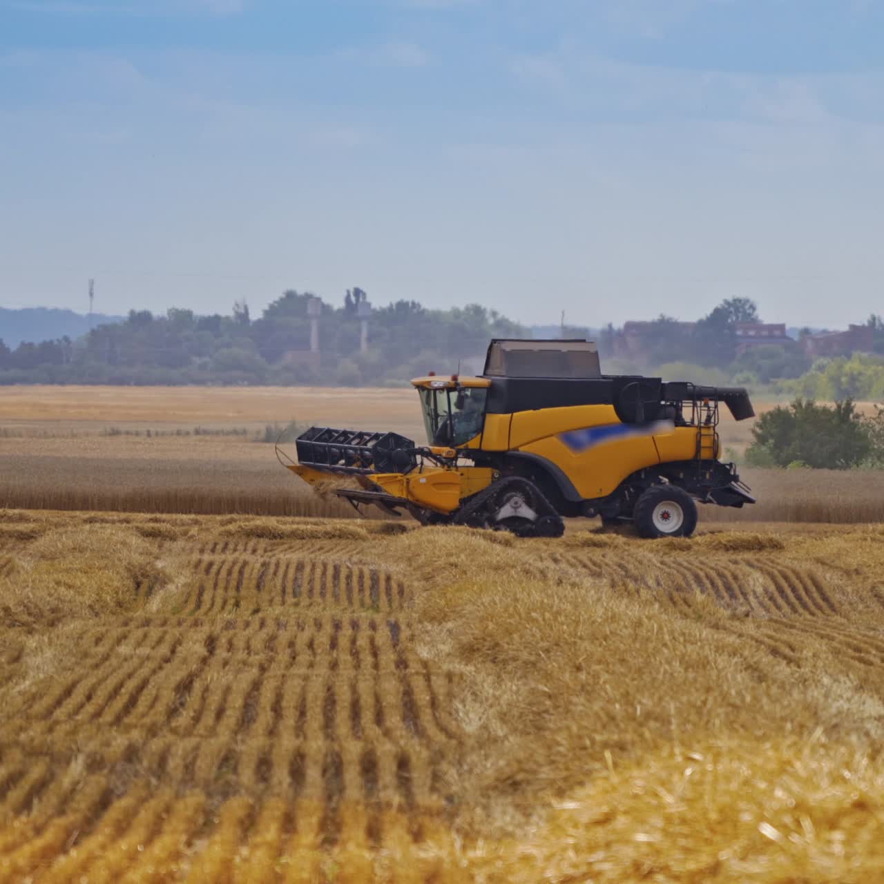 Modern combine harvester on the field. Agricultural machine in the rural place at seasonal works. Food industry concept.