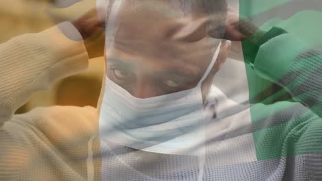 Animation-Der-Flagge-Der-Elfenbeinküste,-Die-Während-Der-Covid-19-Pandemie-über-Einem-Mann-Mit-Gesichtsmaske-Weht