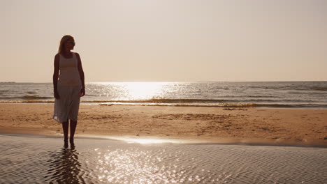 Lonely-Silhouette-Of-A-Young-Man-Sitting-On-The-Sand-By-The-Sea