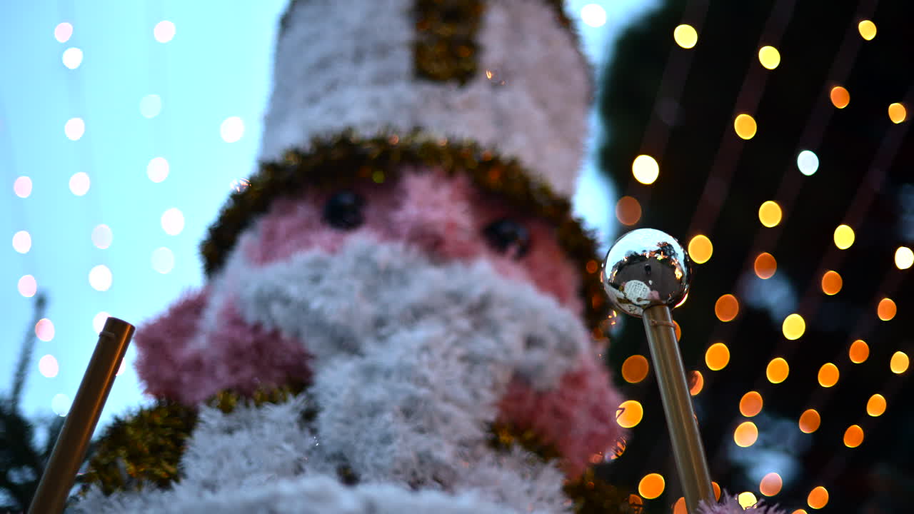 Decorative Christmas nutcracker soldier figure displayed outdoors with trees in the background