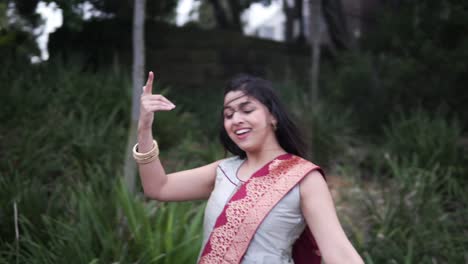 Beautiful-Indian-Woman-Dancing-Classical-Dance-In-The-Garden---medium