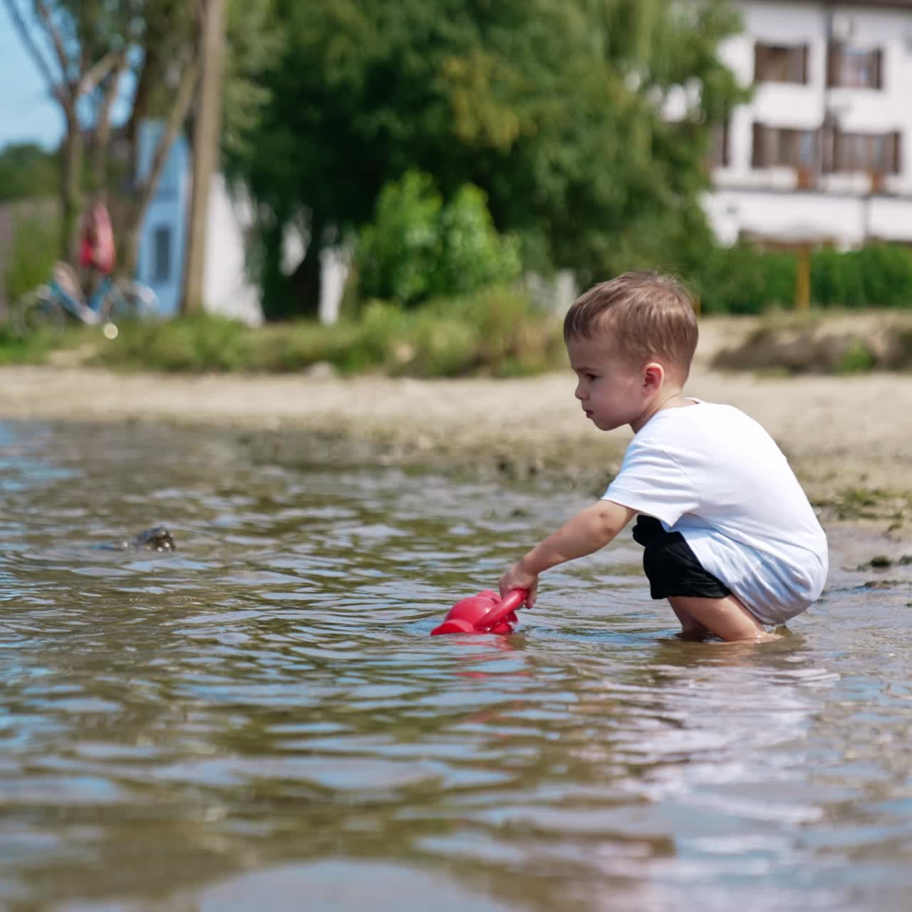 Small boy on river beach playing. Water activity lifestyle