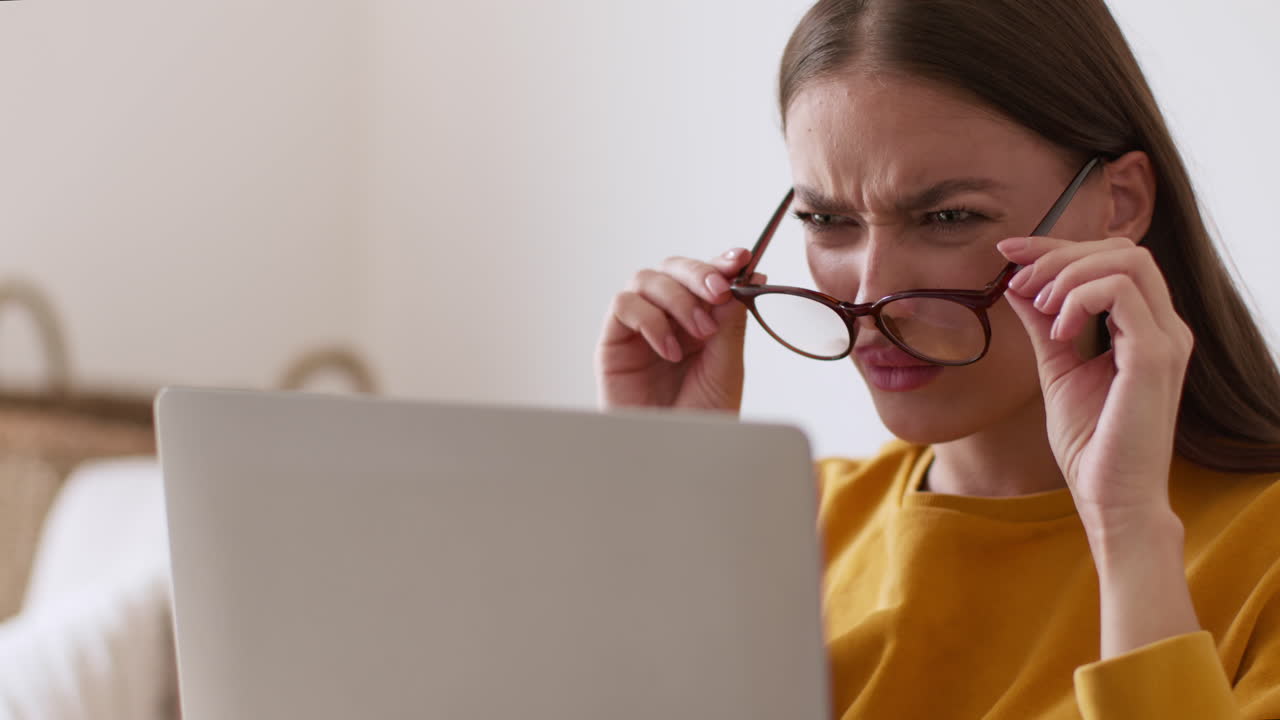 Woman struggling to see laptop screen