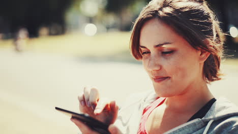 Woman-using-digital-tablet-computer-ipad-outdoors-in-nature