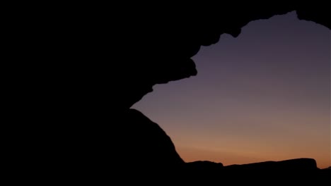 sunset through rock arch