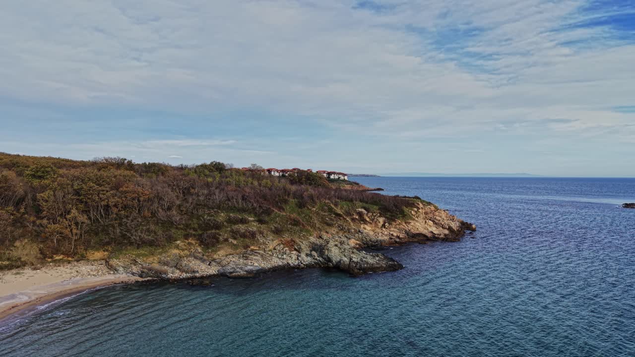 Scenic aerial view of a tranquil beach and coastline by the sea