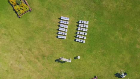 turning camera rises above wedding venue on lush grass