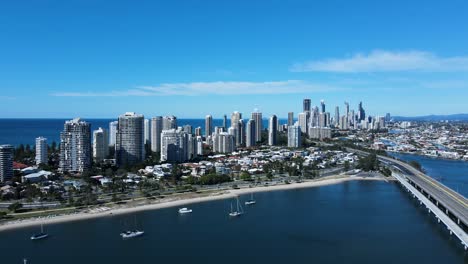 Aerial-view-of-a-coastal-urban-metropolitan-sprawl-with-a-towering-high-rise-skyline-and-city-infrastructure-below