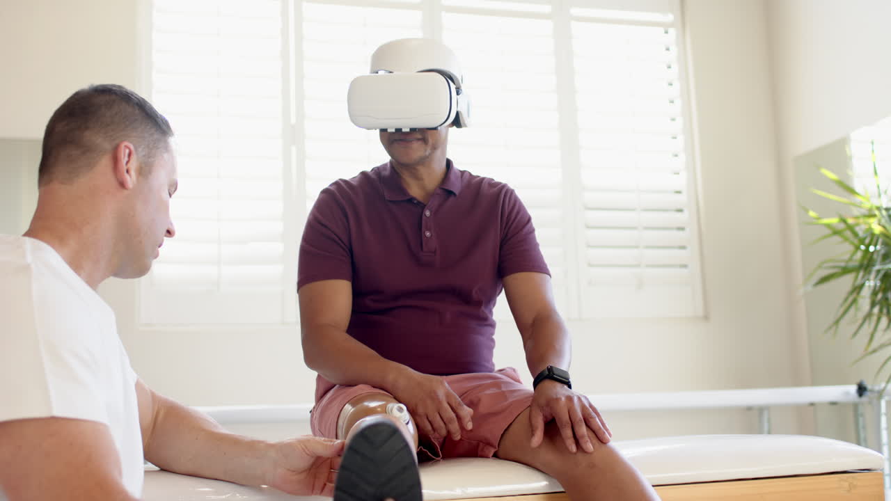 Using VR headset, man with prosthetic leg undergoing therapy session