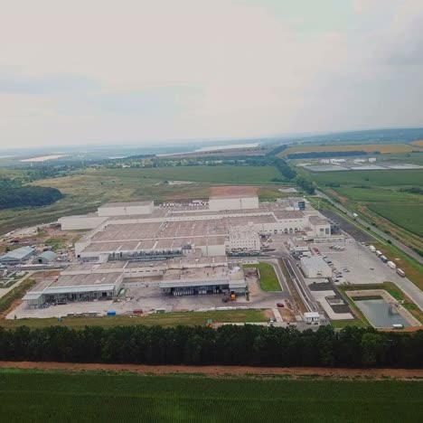 territory of the woodworking plant from above on the background of the countryside. aerial view