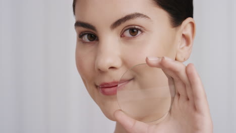 close-up-portrait-beautiful-young-caucasian-woman-holding-magnifying-glass-showing-smooth-healthy-skin-happy-female-smiling-enjoying-soft-perfect-complexion-skincare-concept