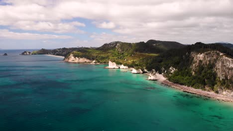 Cathedral-Cove,-The-Hoho-Rock,-Hahei-Beach-aerial-orbit-shot