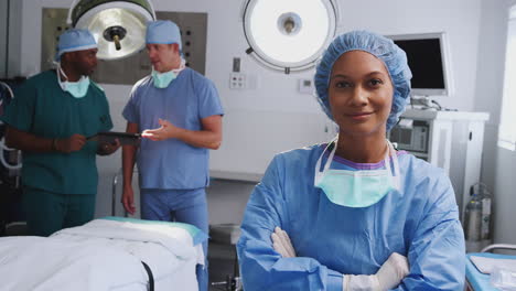 portrait of female surgeon wearing scrubs in hospital operating theater