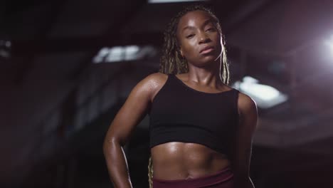 studio portrait of woman wearing fitness clothing standing in gym 2