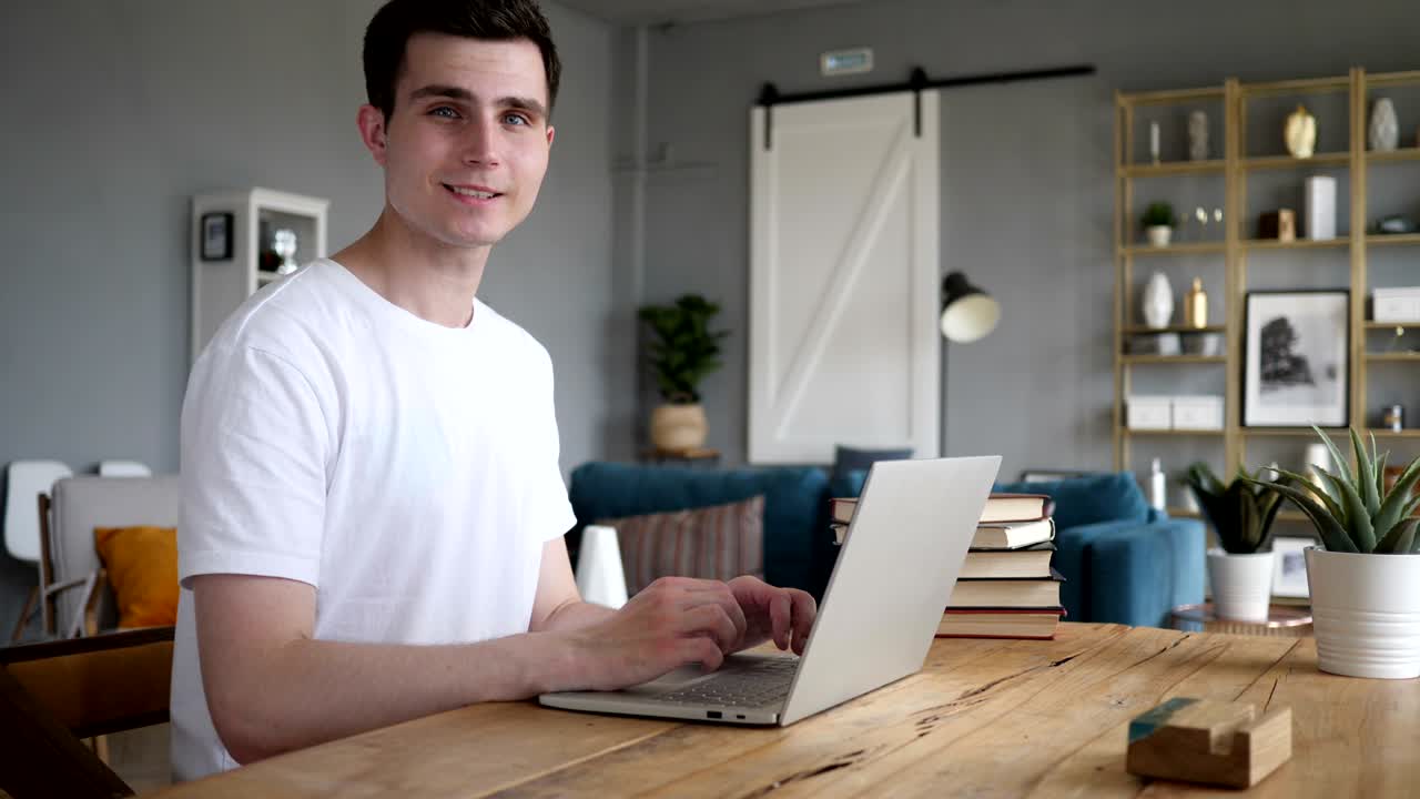 Portrait of Serious Adult Man Looking at Camera while Working on Laptop
