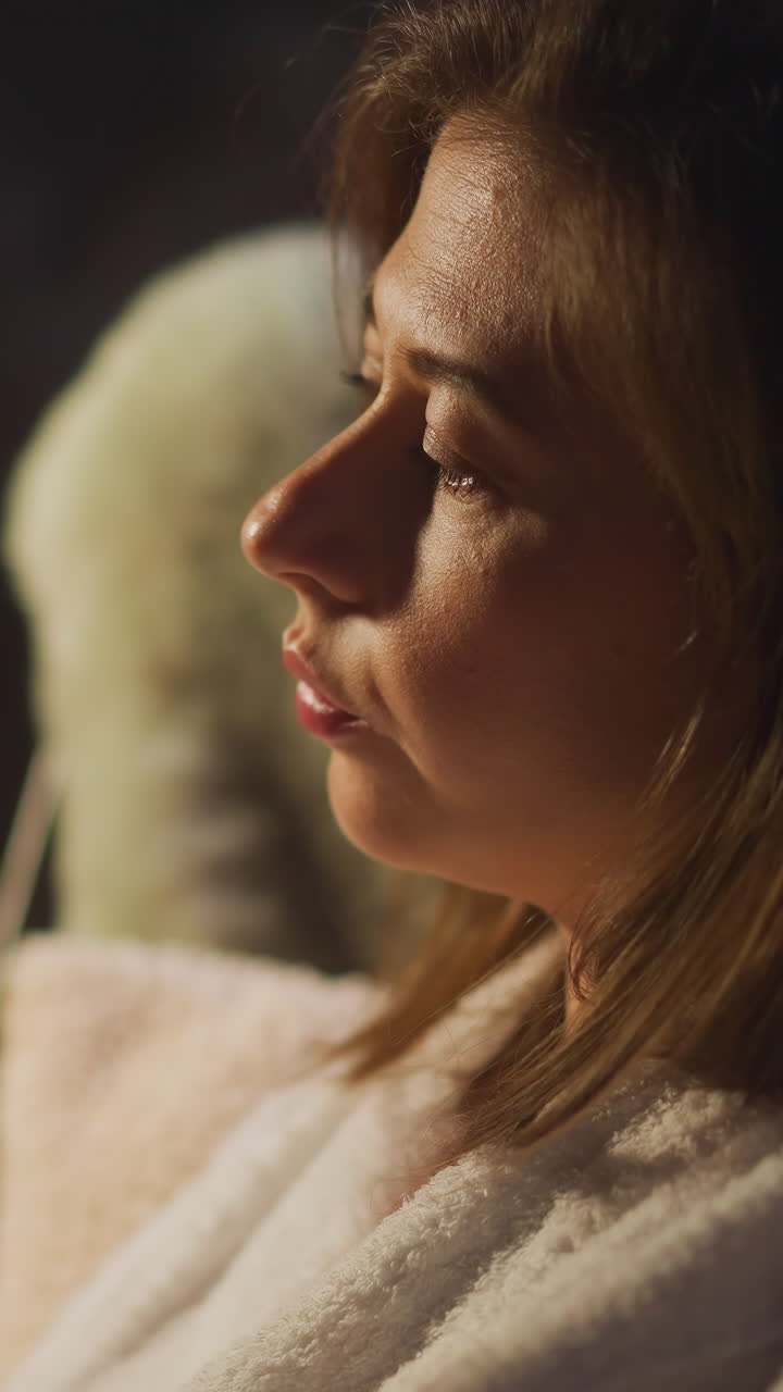Woman suffering from alcohol addiction drinks champagne from glass thinking about life. Health problems and depression during hotel holiday slow motion