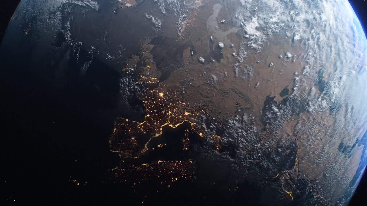 Stunning CGI mid-shot of the planet Earth from space with dawn spreading across the European continent, with the distinct lights from habitation glittering in the night time zones