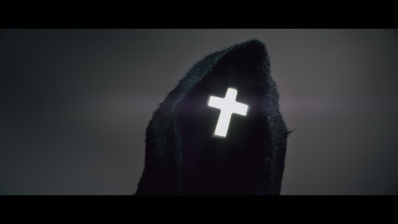 Masked man with cross of light glowing on his face moves his head up