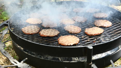 Large-grill-with-many-burgers-being-cooked-on-an-outside