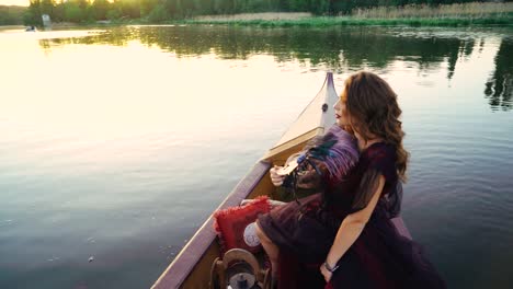 уoung woman in a red dress in a boat on the river.