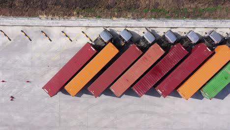 cargo trucks parked to receive products from the warehouse.