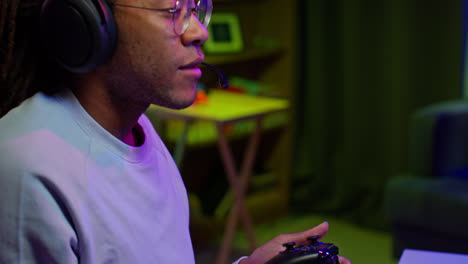 man playing video games with headset