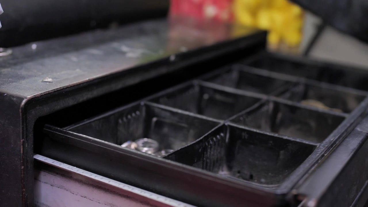 Cashier open cash register drawer machine to give customer change