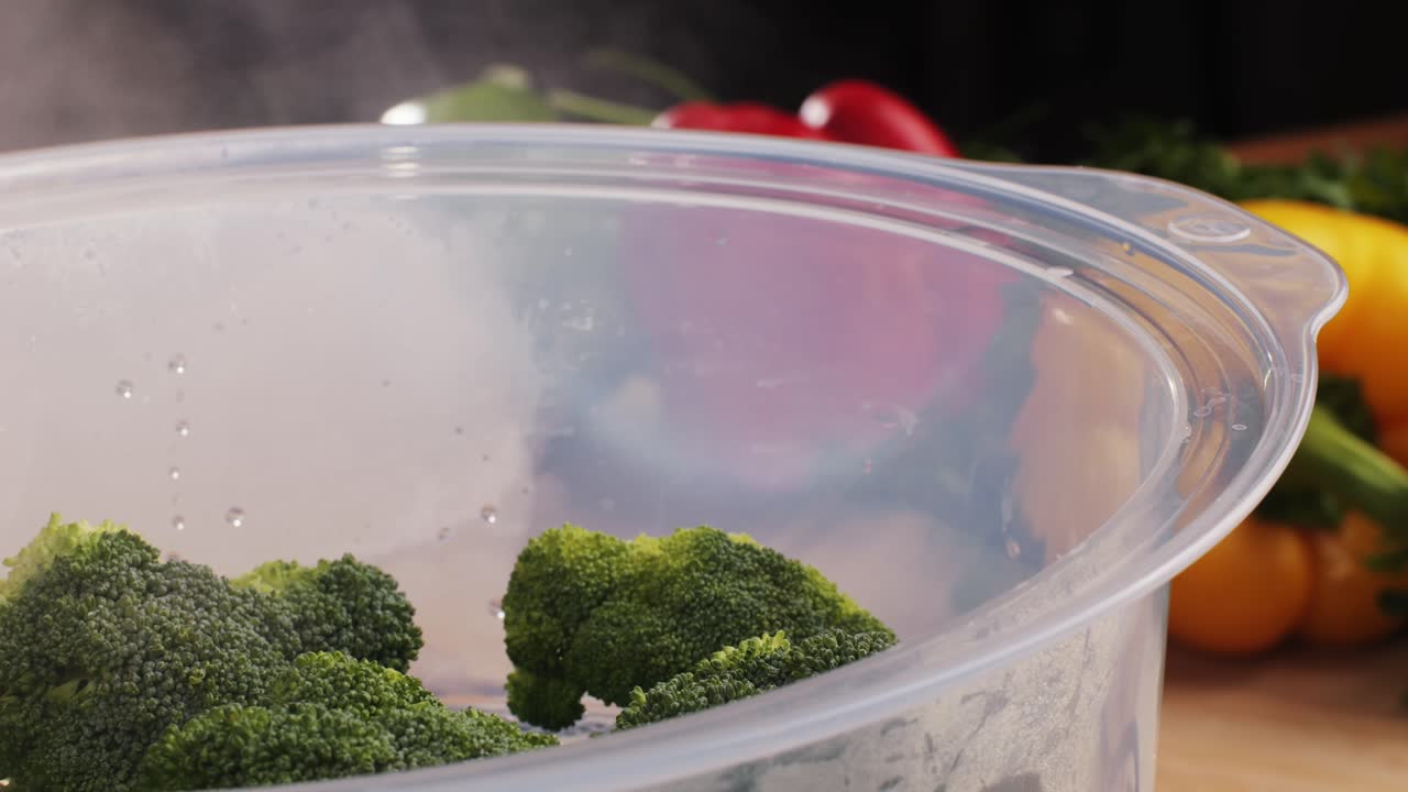 Mixed vegetables, carrots, broccoli, and cauliflower in a food double boiler steamer basket in a stainless steel pot, healthy diet cooking method preserving minerals, vitamins and flavor