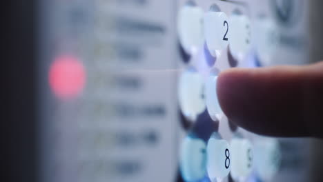 a person enters a pin code on a backlit keyboard 2