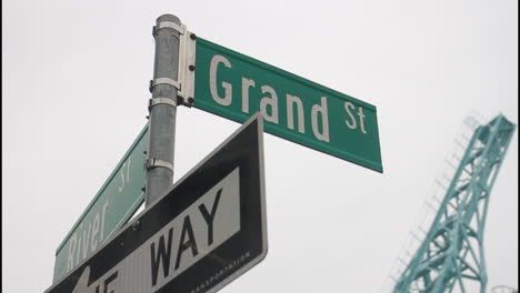 grand street and river way intersection sign
