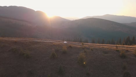 Newlyweds-walking-on-a-high-slope-of-the-mountain.-Groom-and-bride.-Aerial-view