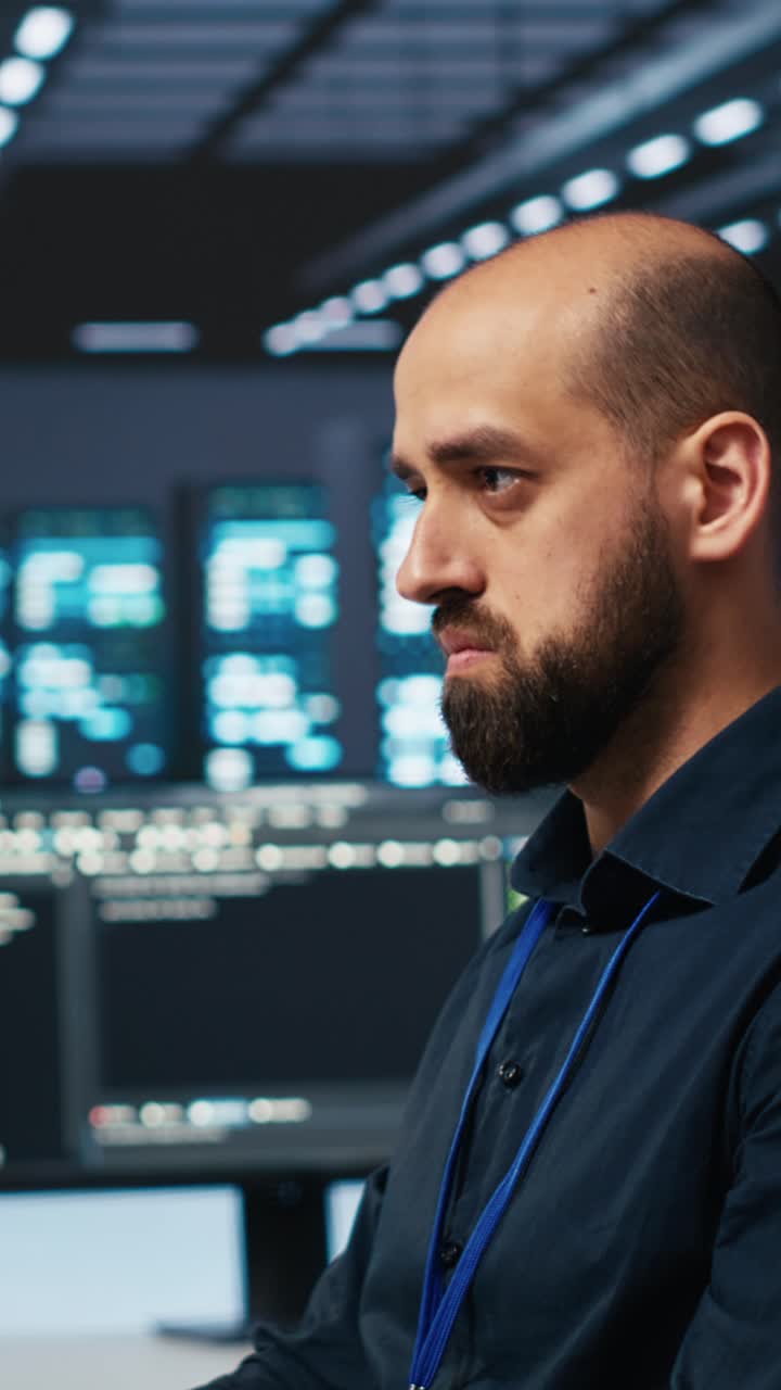 Focused Programmer Typing on Keyboard in Data Center