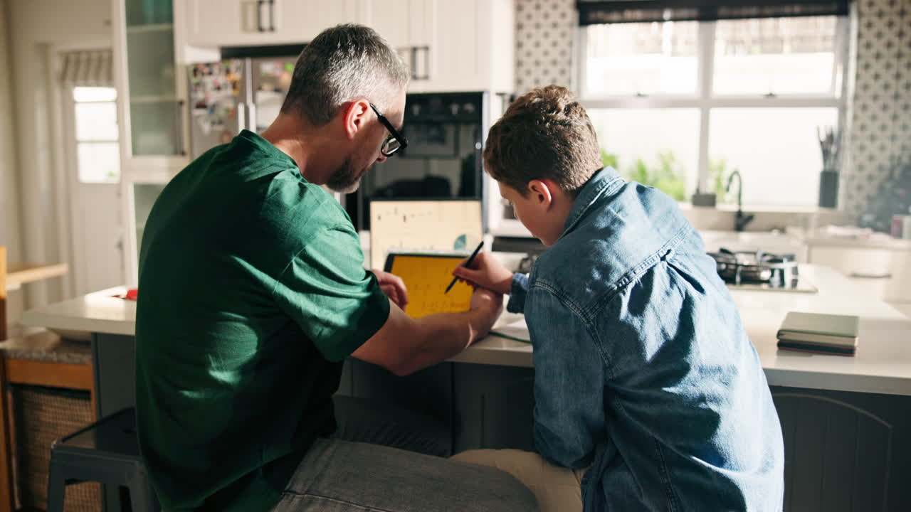 Father and Son Working on Tablet in Kitchen